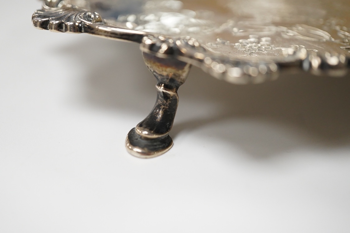 A George III silver waiter, John Cox, London, 1771, of shaped circular form, with later decoration, on three hoof feet, 16.7cm, 7.2oz.